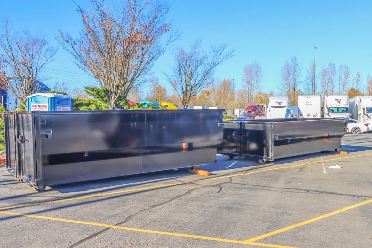 Professional dumpster rental service with roll-off container on residential driveway in Hadley